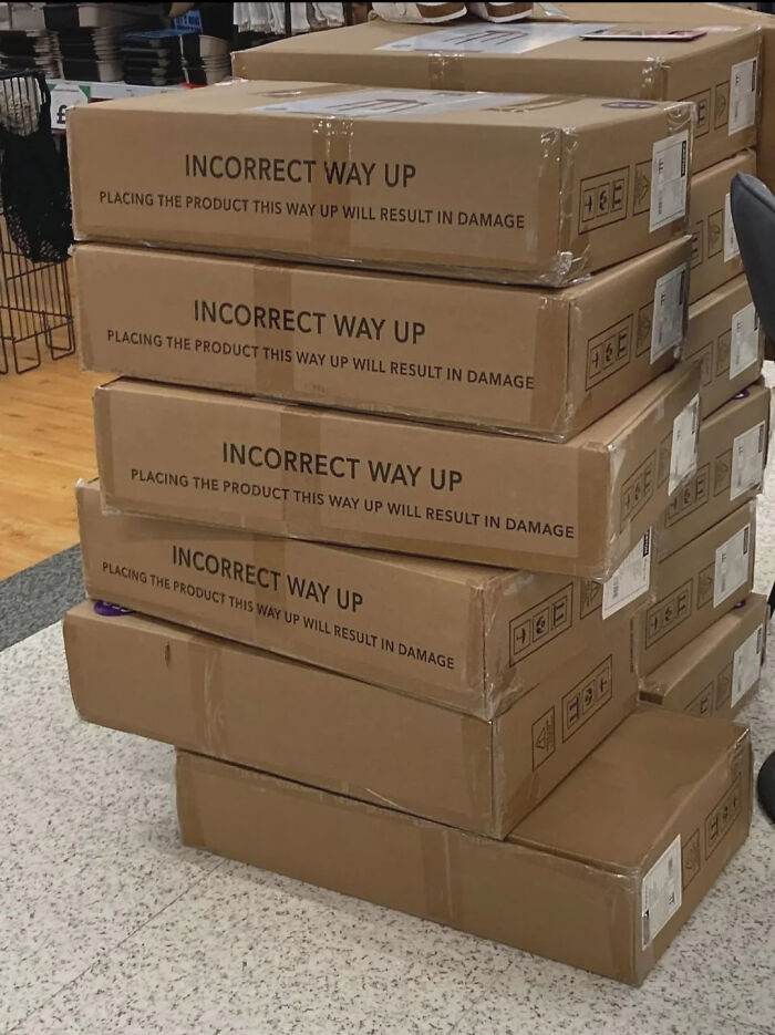 Stacked boxes labeled incorrect way up design fail