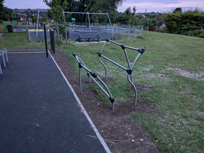 Awkwardly designed metal bars fail as outdoor playground equipment with no clear function