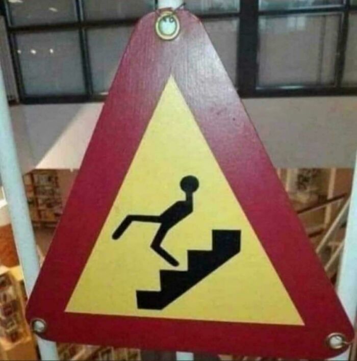Warning sign with poorly designed falling figure on stairs