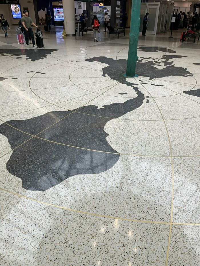 Airport floor map blocked by a pillar, showcasing a design fail in world map layout