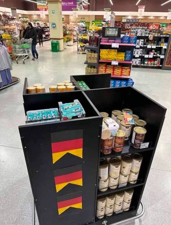 Awkward supermarket display with mismatched German flag shapes and product shelves