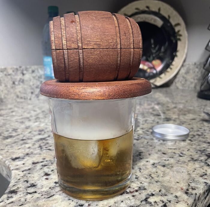 Wooden whiskey barrel ice mold chilling drink on kitchen counter Father's Day gifts