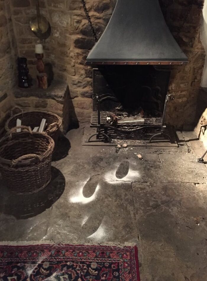 Footprints on the floor in front of a fireplace, left by an amazing father, celebrating the spirit of parents and dads.
