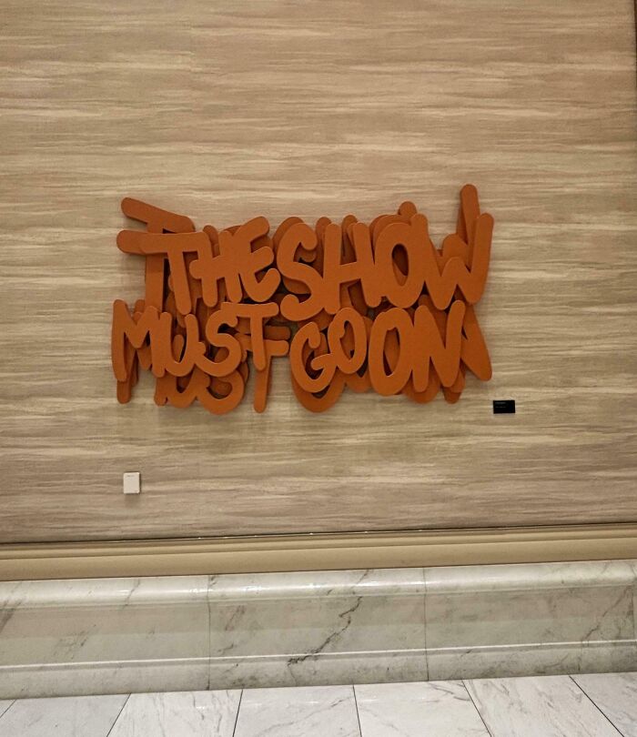 Wall text the show must go on with overlapping letters design fail