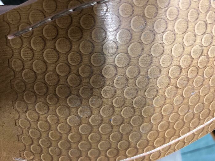 Close-up of a shoe sole with a pattern of small circles, showcasing a bad clothing design.