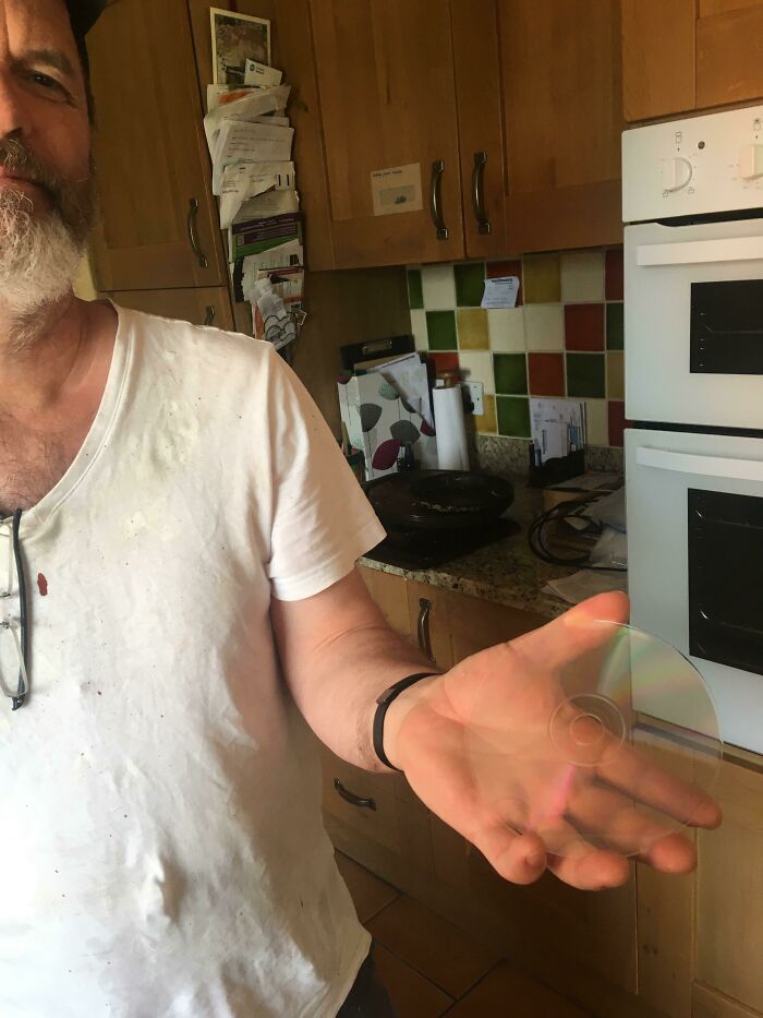 A dad holds a CD, demonstrating a simple yet amazing moment of a father being a parent.
