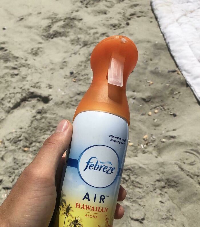 An amazing father uses Febreze Air Hawaiian on a sandy beach.