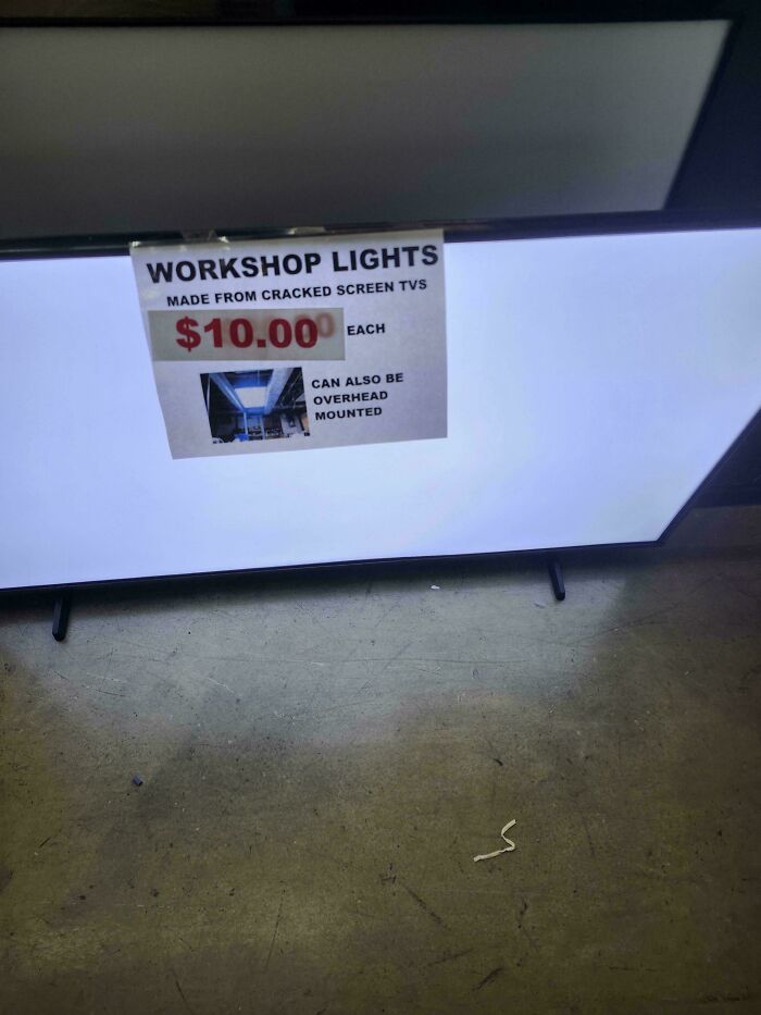 A sign advertising workshop lights made from cracked screen TVs, an example of clever solutions.