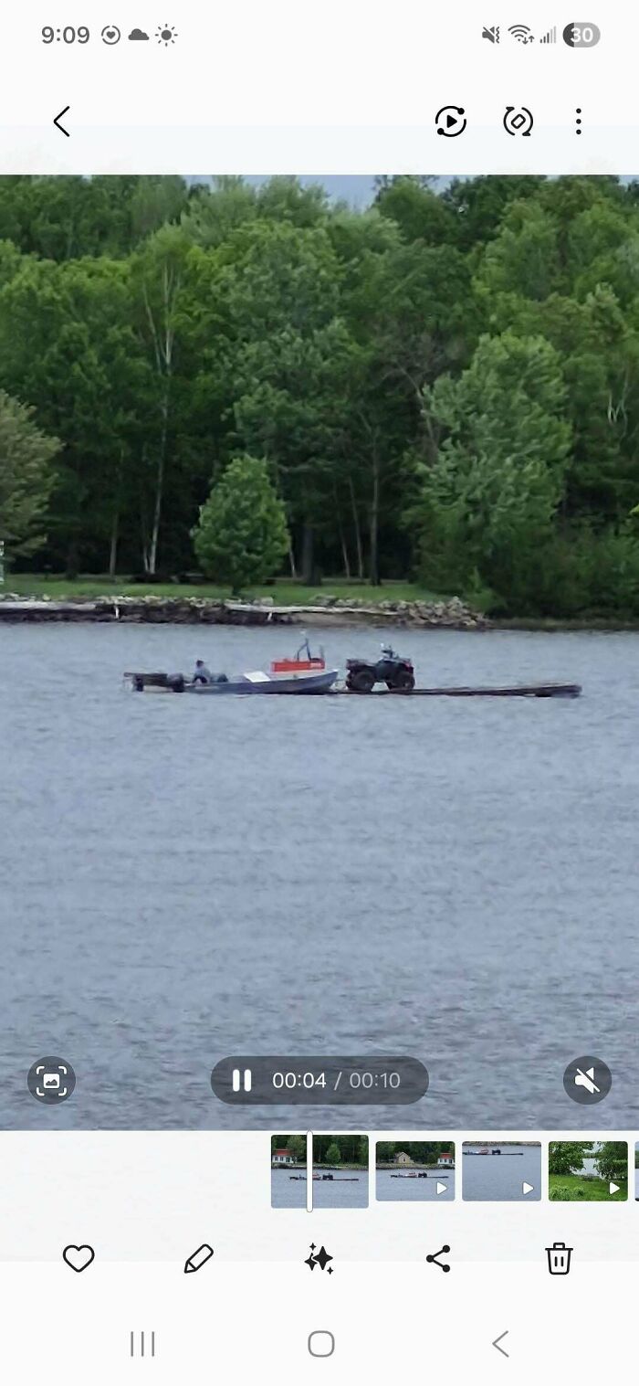 A boat and ATV on a floating dock, representing clever solutions for water transport on a lake.