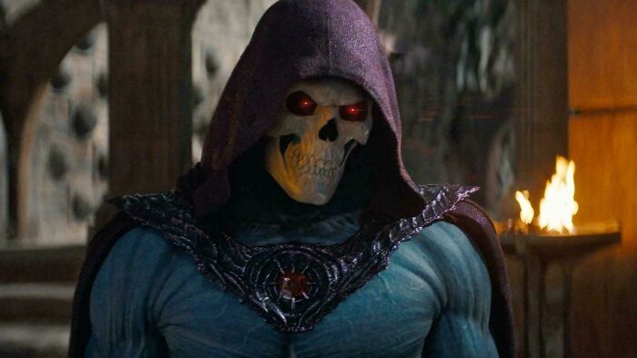 Skeletor with glowing red eyes and a purple hood, in a dark setting, for nonsensical movie details.