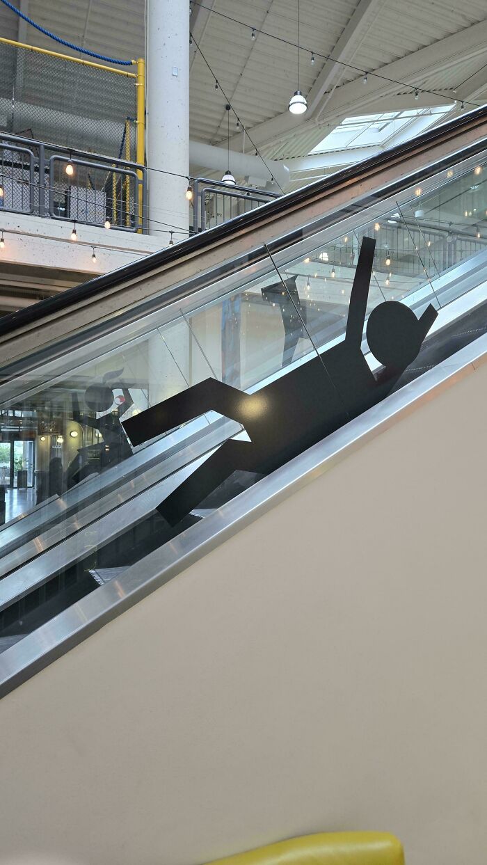 These Stickers On The Escalator That Appear To Be Encouraging Children To Slide Down Outside The Railing