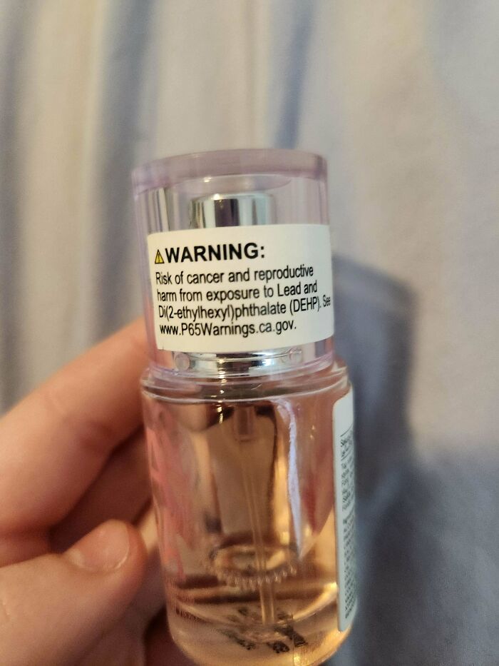 A small bottle with a warning label about cancer and reproductive harm, one of many baffling images.