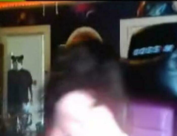 A blurred photo of a person wearing cat ears in a room, capturing a funny and weird internet moment.