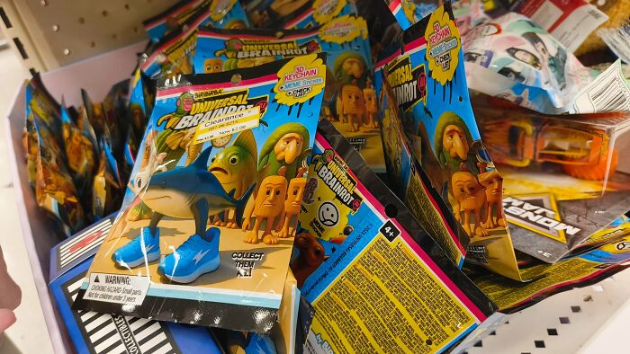 Cringey People blind bag toys featuring a shark with shoes and other characters in a bin at a store.