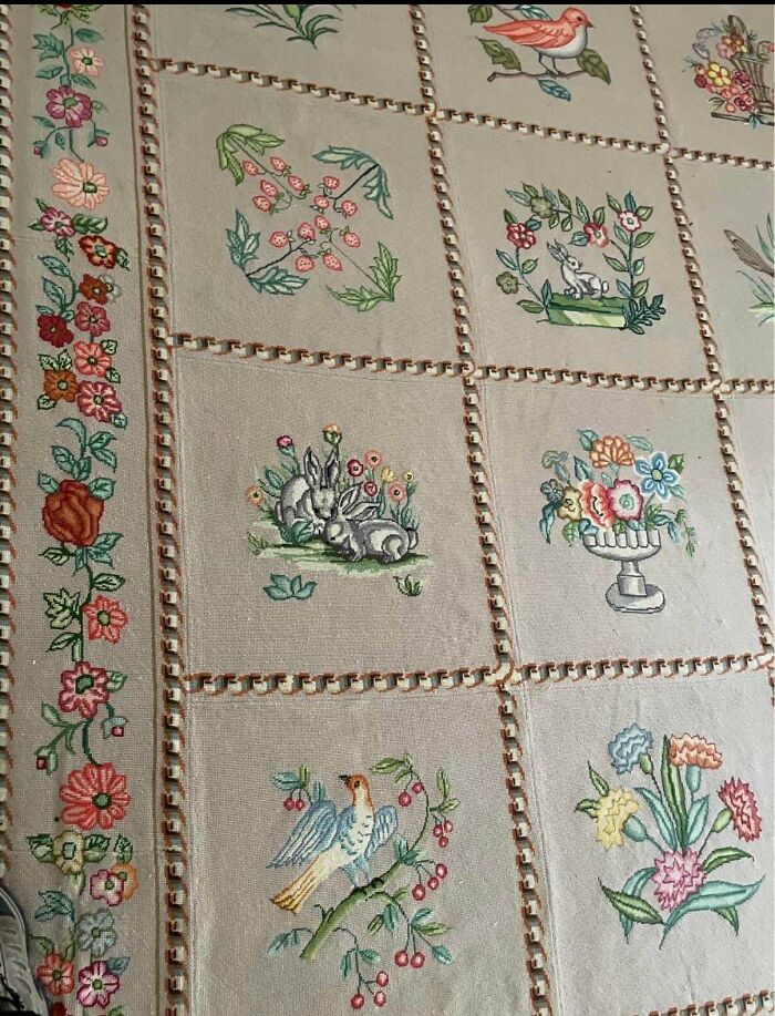 Detailed embroidered quilt panels featuring floral patterns and rabbits among antique lovers treasures