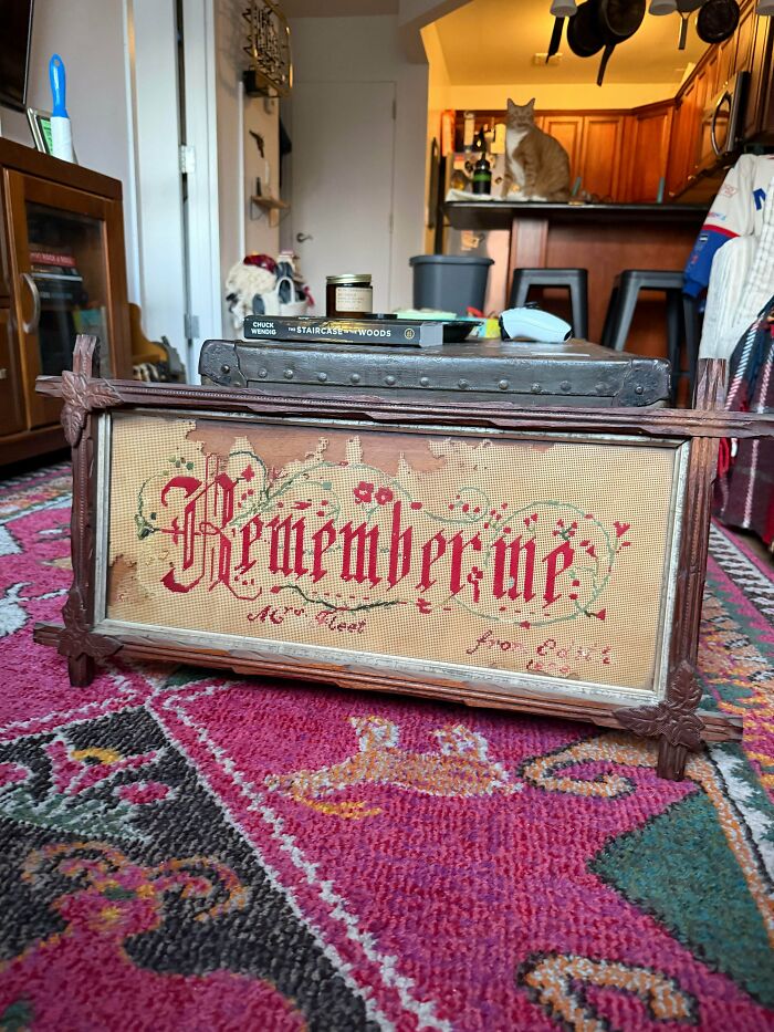A framed vintage needlepoint artwork with the words Remember Me for antique lovers.