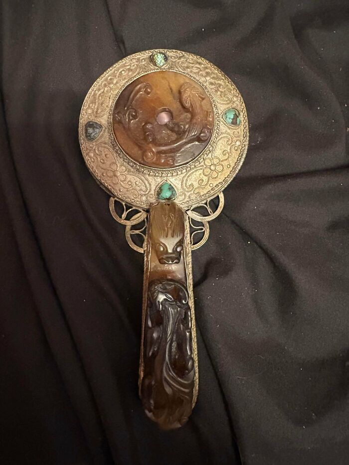 Ornate hand mirror with stone embellishments, a unique find for antique lovers searching for old treasures.