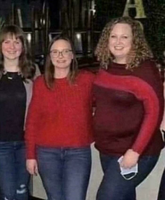 Three women standing together; the middle woman's arm appears to be wrapping around the right woman, a glitch in the matrix.