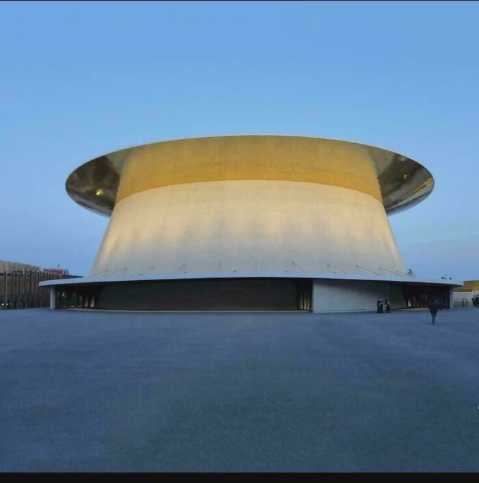 An architectural structure with a golden top and white base, looking like a Glitch in the Matrix.