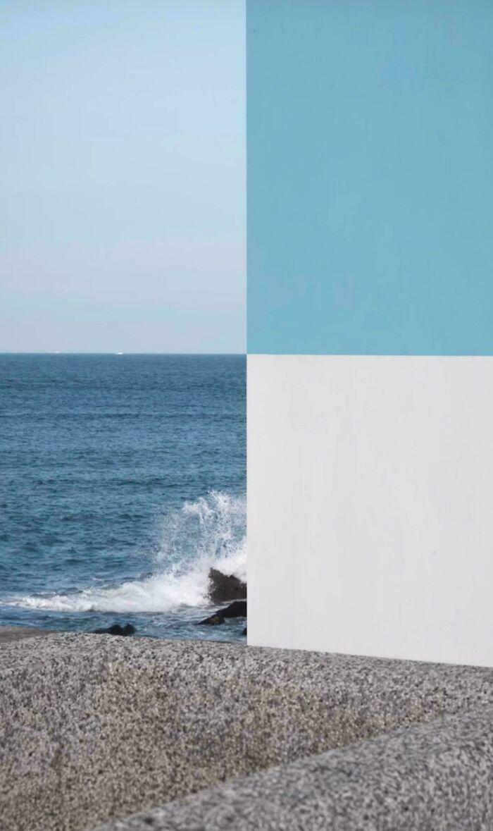 An abstract image of a coastline divided by color blocks, resembling a glitch in the matrix.