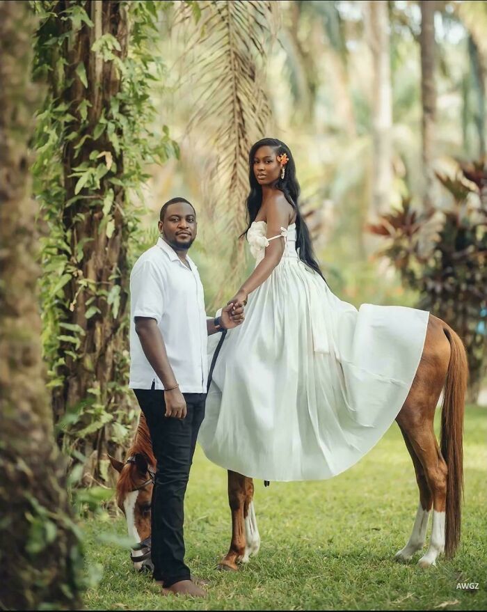 A man holds a woman's hand as she sits on a horse, creating the illusion of her being half-horse, a glitch in the Matrix.