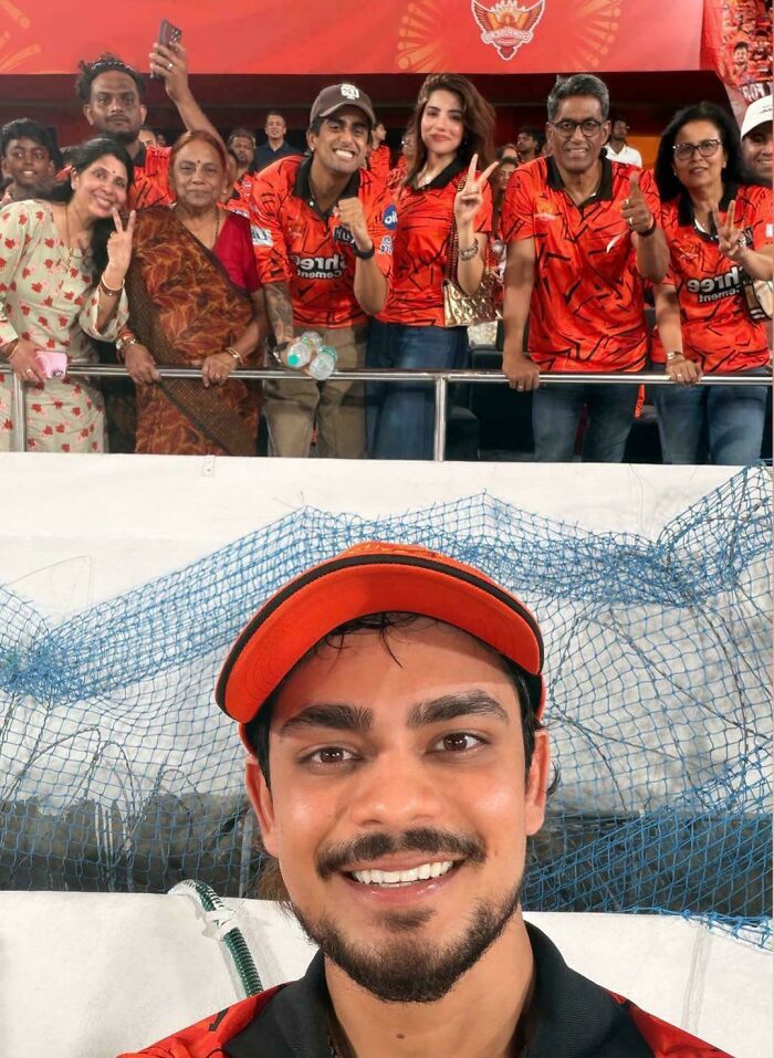 A happy crowd and smiling man in a baseball cap and beard, creating a glitch in the matrix with duplicated faces.