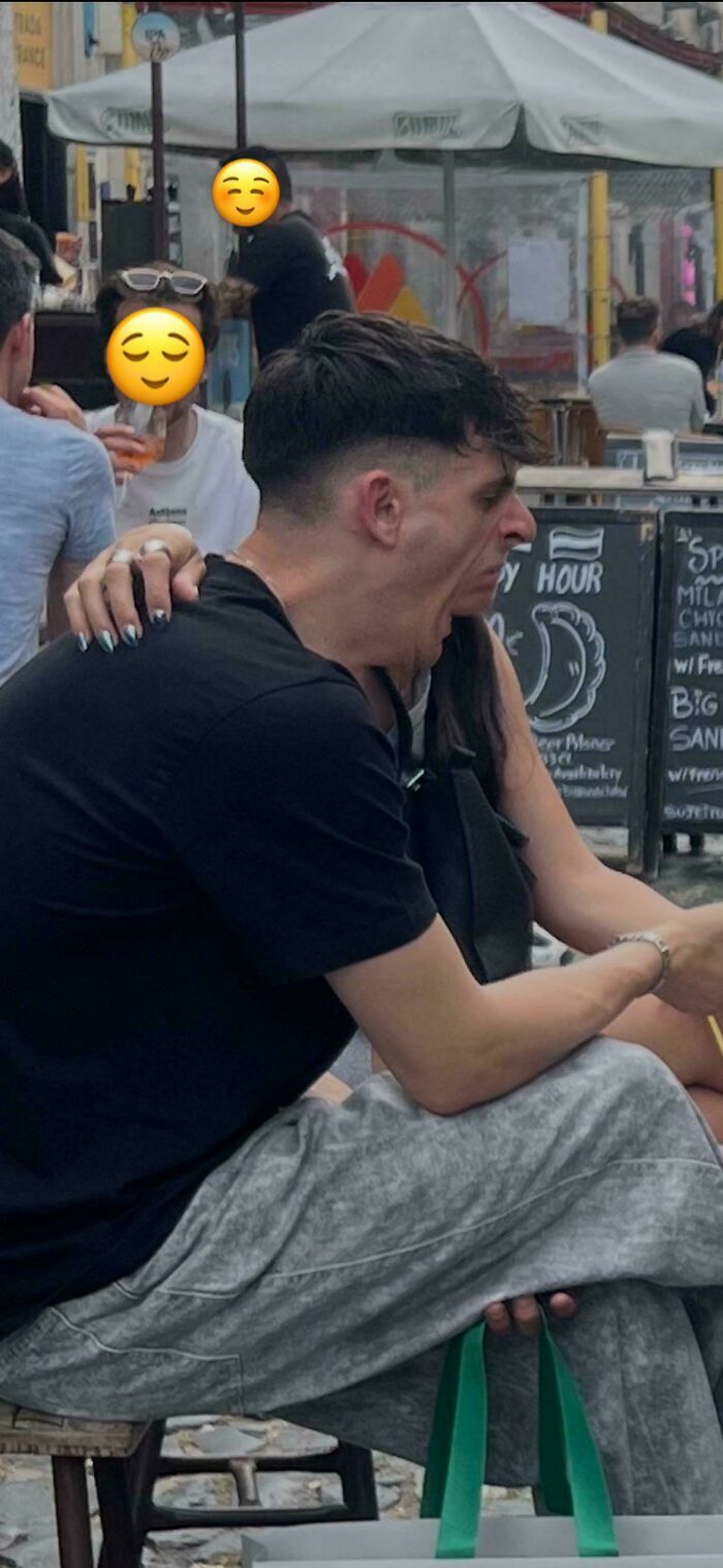 Man yawning at an outdoor cafe, a glitch in the matrix with unusual head placement.