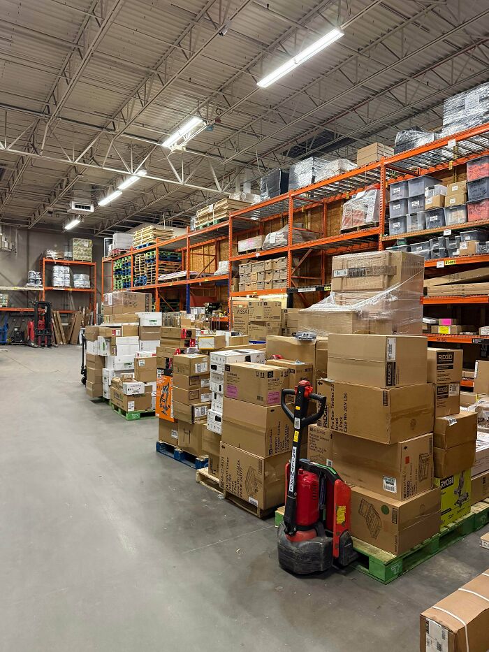 A warehouse floor filled with boxes and equipment handled daily by Home Depot employees