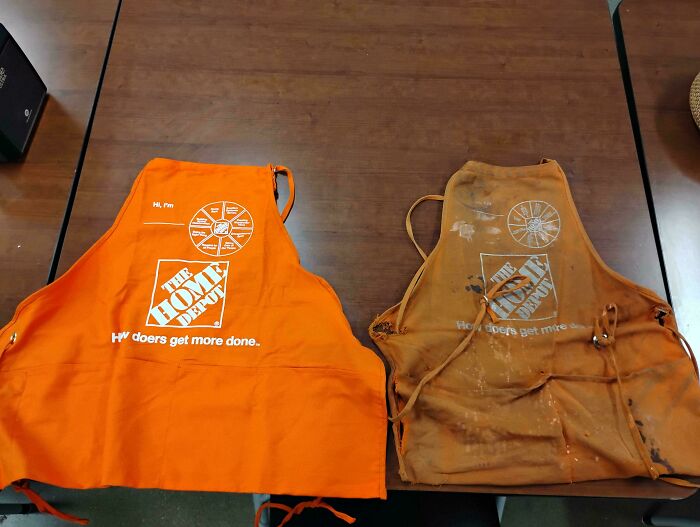 A comparison of a brand new and a heavily used orange apron worn by Home Depot employees