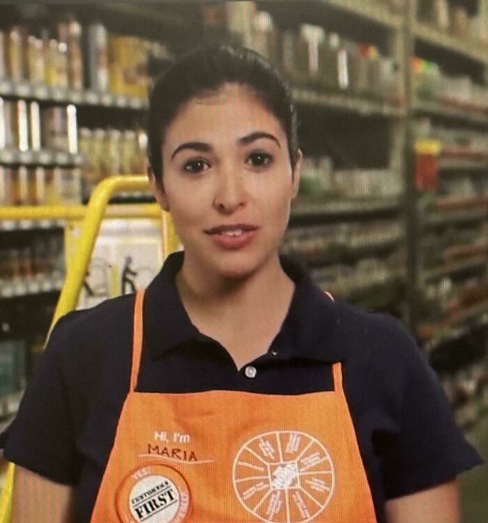 Portrait of a female worker wearing an orange apron, featured in Home Depot employees posts