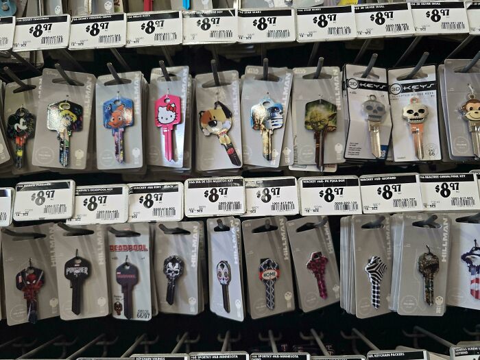 Various themed and custom keys on display racks at Home Depot employees posts
