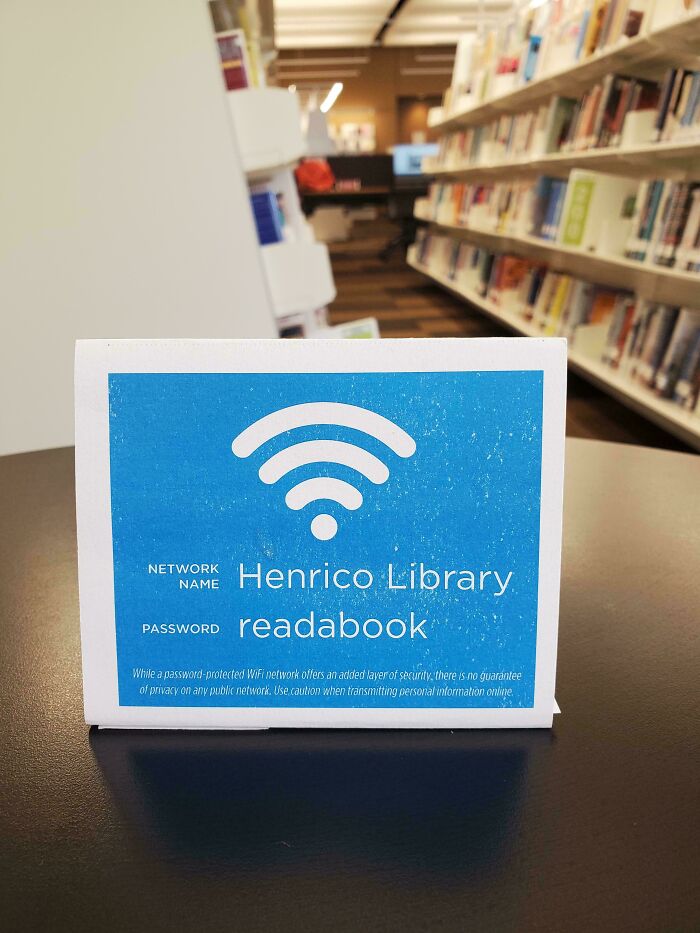 A sign in a library displaying the Wi-Fi network and password, a funny passive-aggressive note.