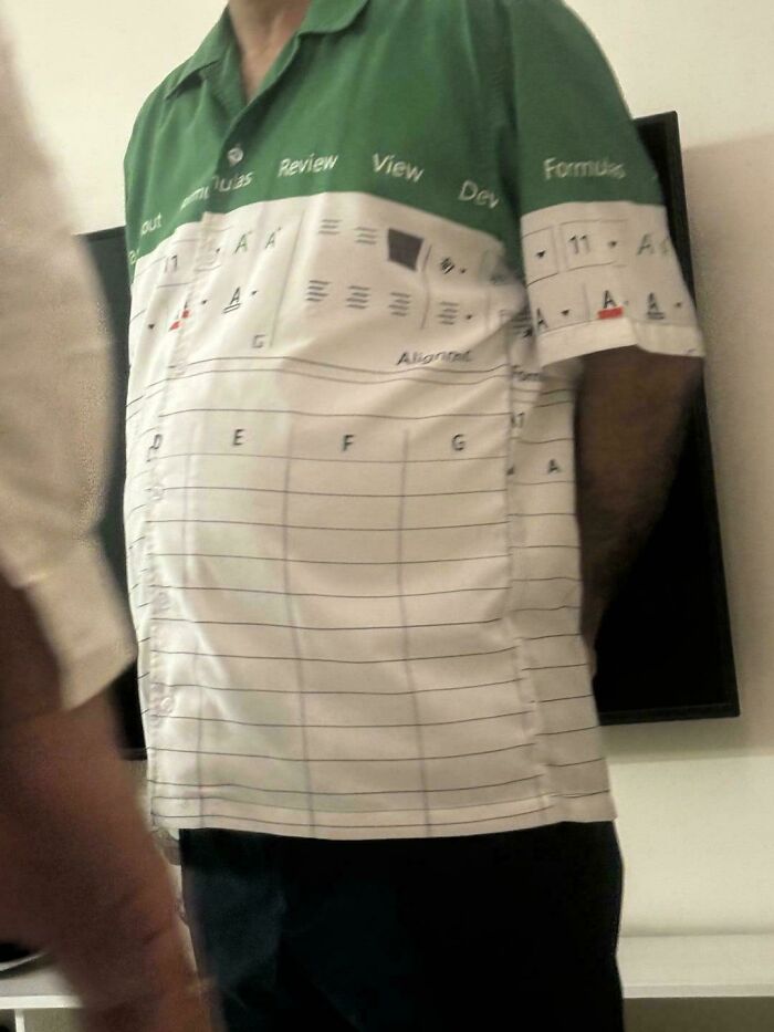 A peculiar man wearing a green and white shirt designed to look like an Excel spreadsheet.