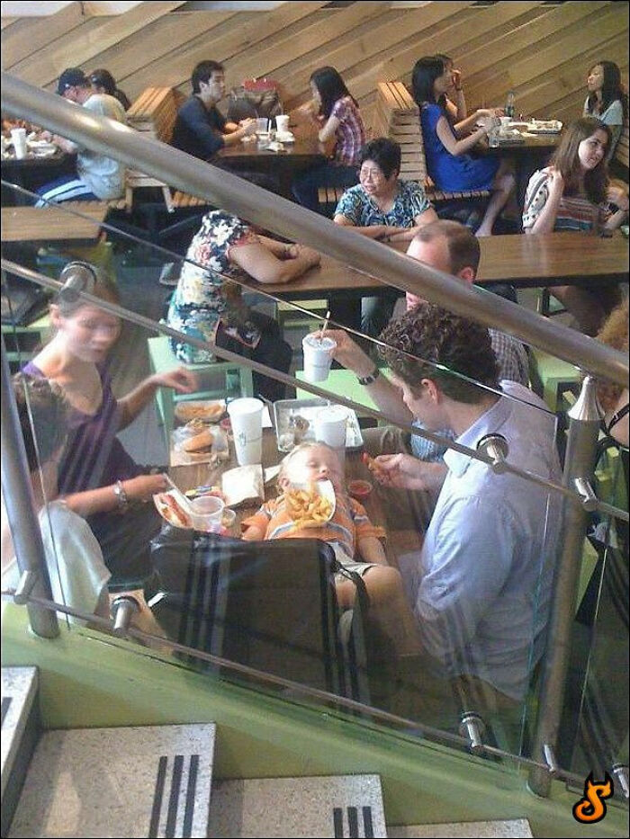 Peculiar things spotted in real life: A baby in a high chair eating french fries at a restaurant.