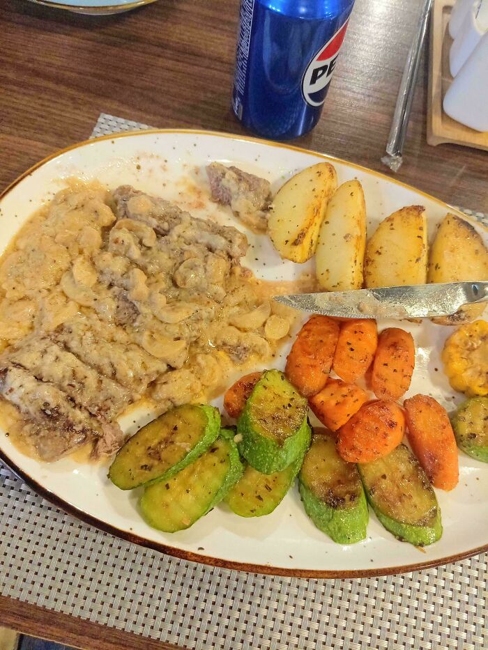 A plate of food with steak, potatoes, carrots, and zucchini, a Not Interesting community photo.
