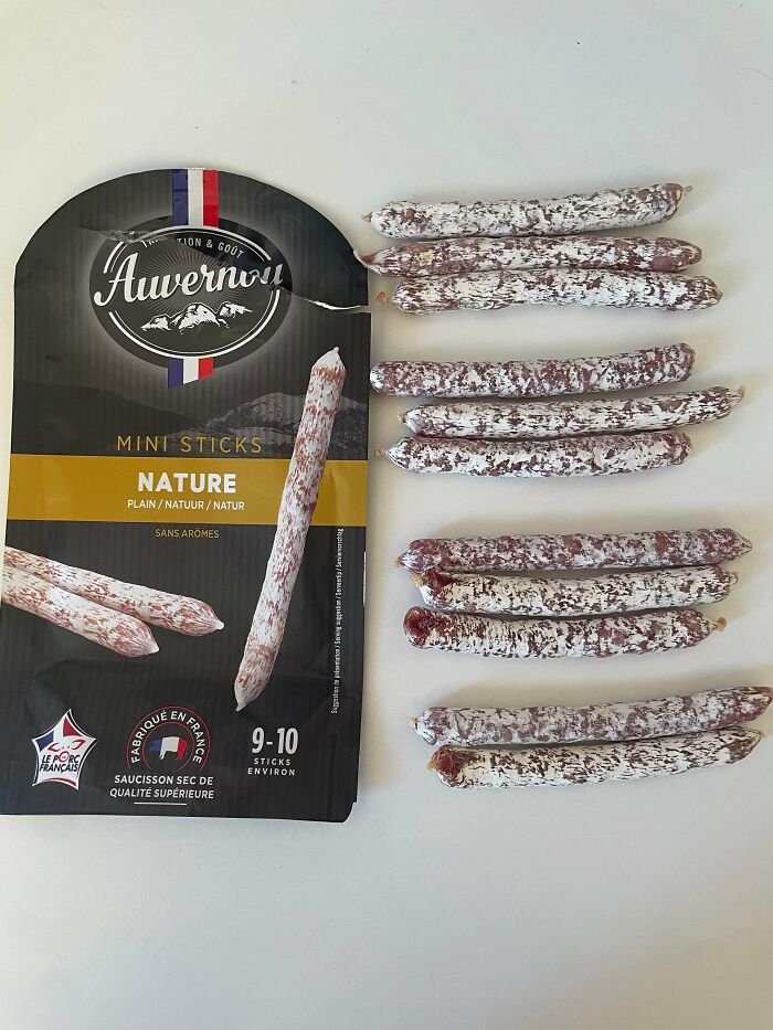 Package of Auvernou mini sticks sausage next to several sausages, shared by the Not Interesting community.