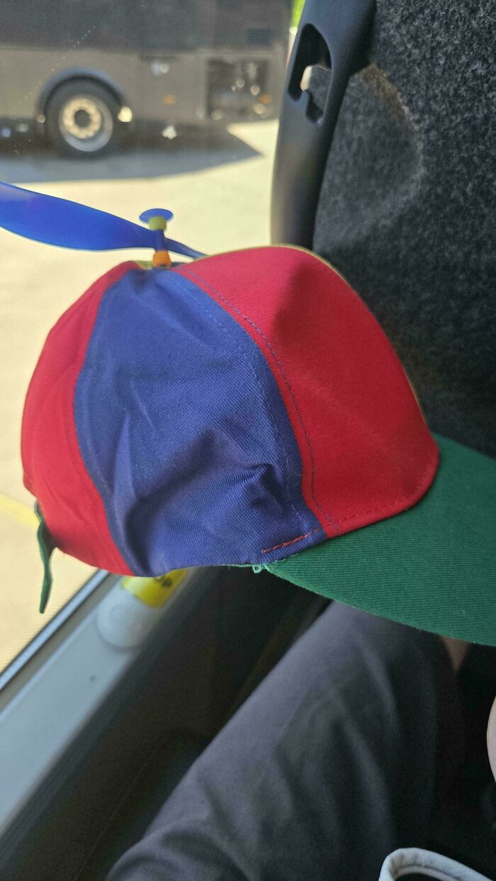 A colorful propeller hat on a bus seat, an amusing image from the “Not Interesting” community.