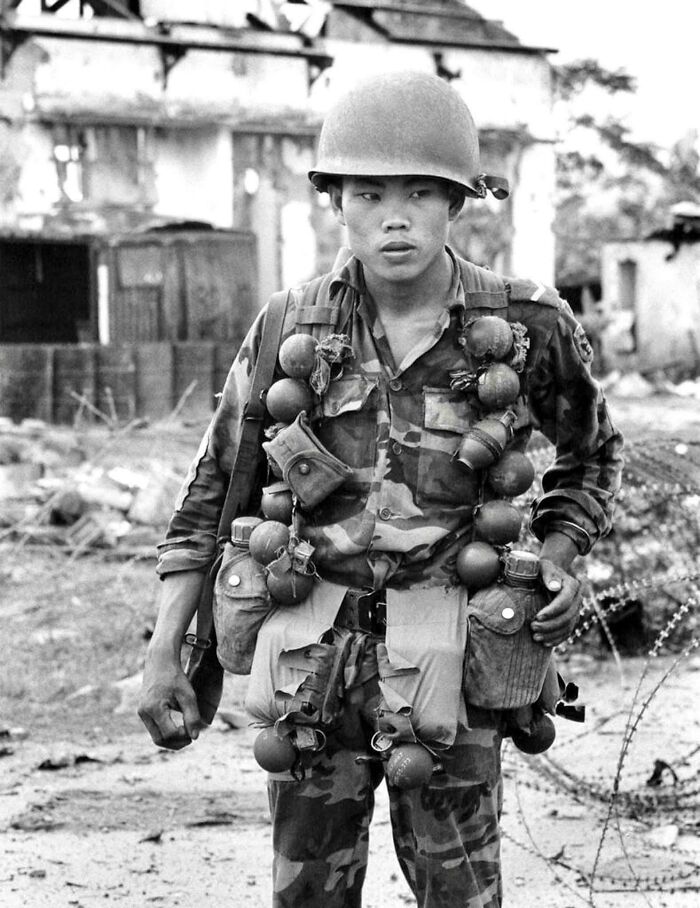 Historical photos of a soldier laden with grenades and gear, standing in a war-torn landscape.