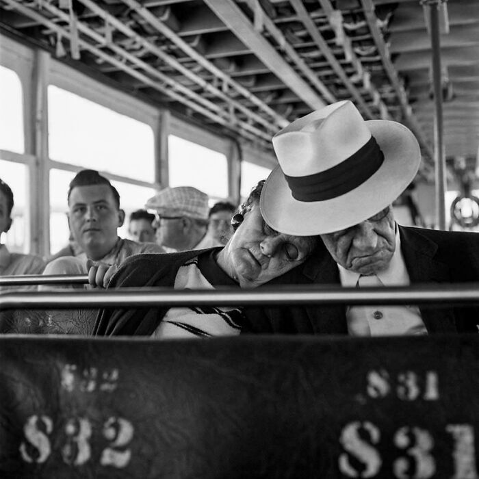 Couple resting on bus seat in tender moment from real past decades photo