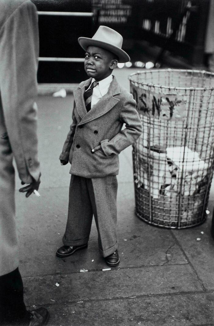 Vintage black and white photo of boy dressed in suit and hat