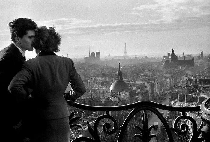 Black and white photo of couple overlooking Paris skyline