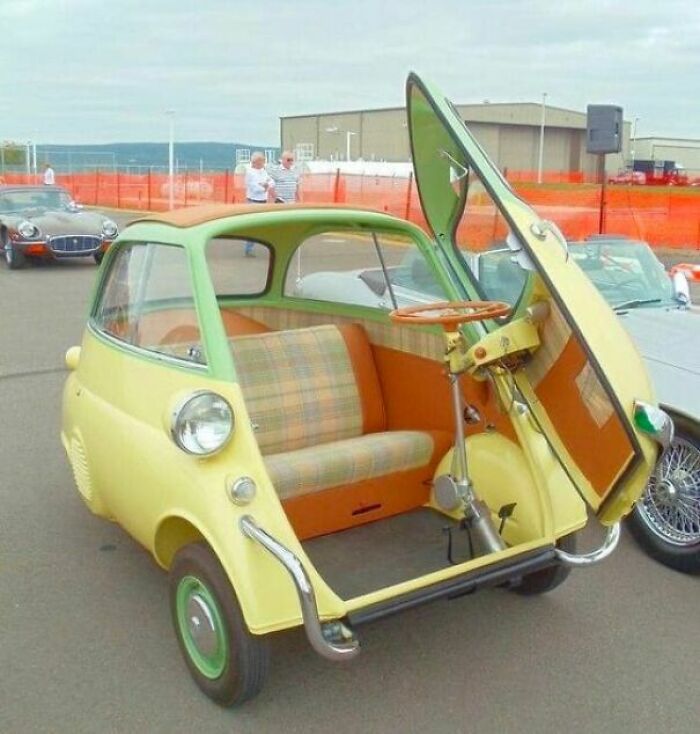 Vintage microcar with front door opening forward showcasing compact design