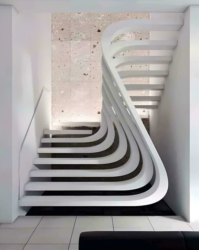Modern staircase design featuring smooth curved edges forming an artistic geometric pattern