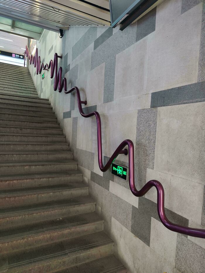 Wavy handrail design on stairway showcasing unique minimalistic design elements