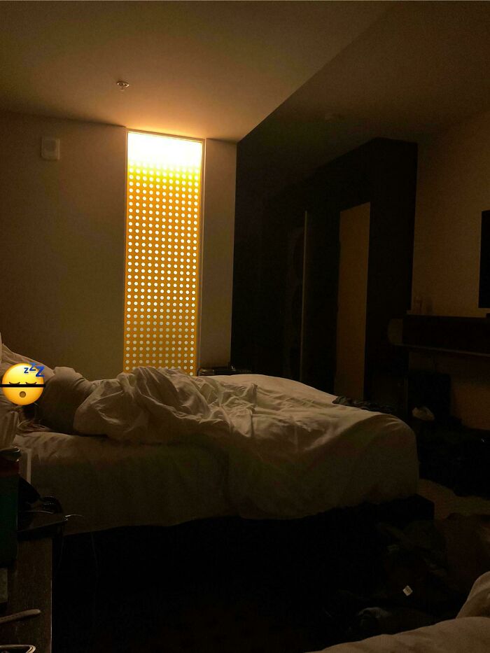 Bedroom window with perforated golden panel blocking light, unique design