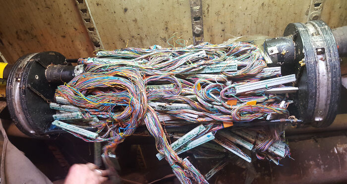 An image of tangled wires from an old server, illustrating an electronics fail.