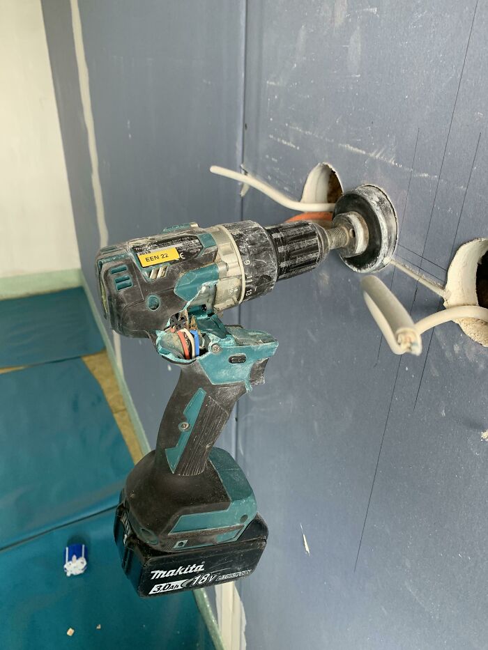 A damaged power drill with exposed wires, illustrating poor electronics practices and fails.