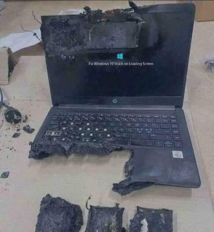 A severely burnt laptop with its internal components exposed, a catastrophic example of electronics fails.