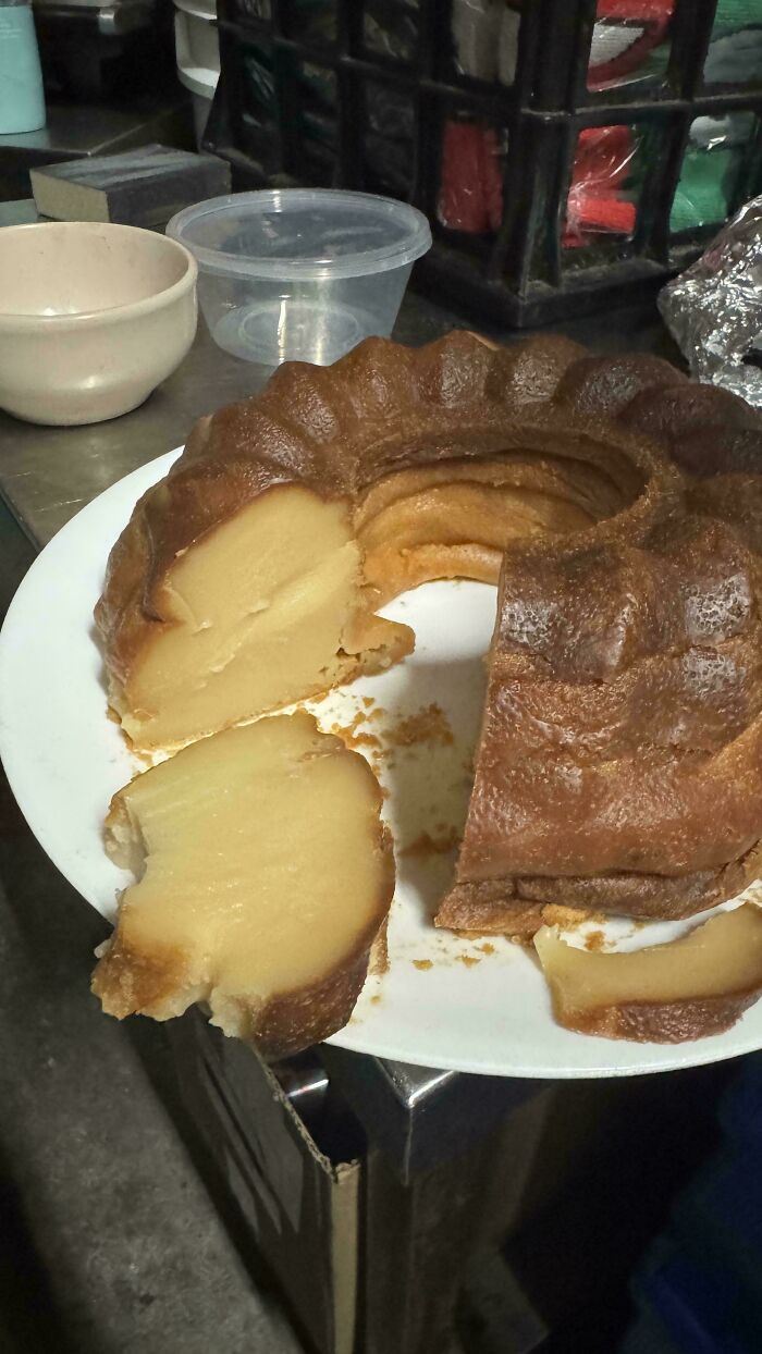 A sliced golden-brown baked treat on a white plate, showing its delicious texture. Bakers creation.