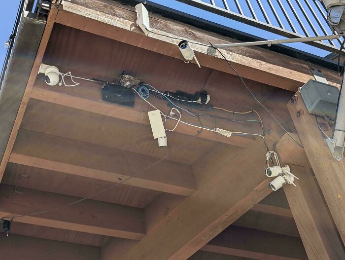 A chaotic mess of wires and security cameras underneath a deck, an example of electronics fails and why IT guys are important.